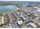 High angle shot of the real estate, showing lake, community pool, retail area and roadway at 10540 77Th Ter # 209, Seminole, FL 33772