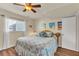 Bedroom with ceiling fan, wood-look flooring, and coastal-themed decor at 10540 77Th Ter # 209, Seminole, FL 33772