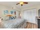 Bedroom with ceiling fan, wood-look flooring, and coastal-themed decor at 10540 77Th Ter # 209, Seminole, FL 33772