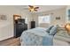 Bedroom with ceiling fan, wood-look flooring, and coastal-themed decor at 10540 77Th Ter # 209, Seminole, FL 33772