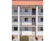 Exterior of the building, featuring multiple units with balconies and an orange roof at 10540 77Th Ter # 209, Seminole, FL 33772