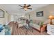 Inviting living room featuring hardwood floors, two sofas and open access to the kitchen at 10540 77Th Ter # 209, Seminole, FL 33772