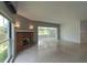 Spacious living room featuring a brick fireplace, terrazzo flooring and a tranquil view at 10828 99Th Pl, Seminole, FL 33772