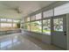 Well-lit sunroom with scenic views and a convenient exterior door at 10828 99Th Pl, Seminole, FL 33772