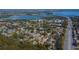 Panoramic aerial view of a residential area near a waterway and bridge, showcasing its serene environment at 112 Forest Cir, Safety Harbor, FL 34695