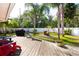 Large backyard deck with a fire pit and seating area, perfect for outdoor gatherings at 112 Forest Cir, Safety Harbor, FL 34695