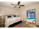 Bedroom with sliding glass doors leading to a screened pool and patio area at 112 Forest Cir, Safety Harbor, FL 34695