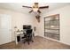 Bedroom with a ceiling fan, a window with blinds, and a small office area at 112 Forest Cir, Safety Harbor, FL 34695