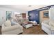 Inviting living room featuring stylish decor, wood flooring, and a large window offering natural light at 112 Forest Cir, Safety Harbor, FL 34695