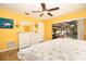 Yellow themed main bedroom with view of pool through sliding glass door at 112 Forest Cir, Safety Harbor, FL 34695