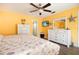 Spacious yellow themed main bedroom with closet and tile floors at 112 Forest Cir, Safety Harbor, FL 34695