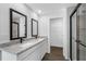 Bathroom featuring double sinks with granite countertops, modern cabinetry, and a glass enclosed shower at 11275 Old Squaw Rd, Weeki Wachee, FL 34614