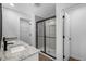 Modern bathroom featuring double sinks with granite countertops and a glass-enclosed shower at 11275 Old Squaw Rd, Weeki Wachee, FL 34614