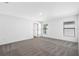 Neutral bedroom with a large window and carpeted flooring, providing a tranquil retreat at 11275 Old Squaw Rd, Weeki Wachee, FL 34614