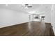 Spacious living room featuring hardwood floors, a modern ceiling fan, and a combined view of the kitchen at 11275 Old Squaw Rd, Weeki Wachee, FL 34614