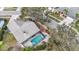 This aerial view showcases the property's proximity to landscaping and the screened pool area at 11308 Pocket Brook Dr, Tampa, FL 33635