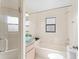 Clean bathroom featuring a shower-tub combination with a glass door and modern fixtures at 11308 Pocket Brook Dr, Tampa, FL 33635