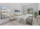 Staged bedroom with a window and sliding door leading to the screened pool area at 11308 Pocket Brook Dr, Tampa, FL 33635