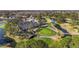 An aerial view showcases the golf course with meticulously maintained green and inviting water features at 11308 Pocket Brook Dr, Tampa, FL 33635