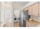 Conveniently located laundry area featuring modern washer and dryer, with kitchen access at 11308 Pocket Brook Dr, Tampa, FL 33635