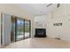 Living room with tile floors, a fireplace, and a large sliding glass door offering a view of the pool at 11308 Pocket Brook Dr, Tampa, FL 33635