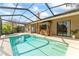 This screened pool features a tiki bar and hot tub for relaxing and entertaining at 11308 Pocket Brook Dr, Tampa, FL 33635