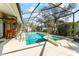 Screened in pool area with a tiki bar and jacuzzi at 11308 Pocket Brook Dr, Tampa, FL 33635