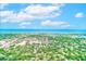 Breathtaking aerial view of a coastal city with ocean views, lush greenery, and clear blue skies at 12200 Vonn Rd # 1305, Largo, FL 33774