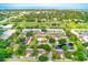 Aerial view showcases the community's layout, landscaping, and nearby golf course at 12200 Vonn Rd # 1305, Largo, FL 33774