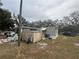 Exterior view of a house with covered porch, shed, truck, and mature trees at 12205 Greenland Dr, Riverview, FL 33579