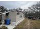 Exterior view of a house with mature trees and yard at 12205 Greenland Dr, Riverview, FL 33579