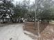 Wide front yard with mature trees leading to the residence, enhancing its curb appeal at 12205 Greenland Dr, Riverview, FL 33579