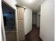 Hallway featuring built-in storage cabinets and leading to multiple bedrooms at 12205 Greenland Dr, Riverview, FL 33579