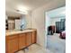 Bathroom with dual sinks and vanity, view to the bedroom, and tiled floor at 12239 Fawn Brindle St, Riverview, FL 33578