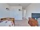 Carpeted bedroom featuring a view of an open doorway, a TV on a dresser, and a small shelf at 12239 Fawn Brindle St, Riverview, FL 33578