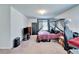 Carpeted bedroom features a four-poster bed, desk, dresser, and good natural light at 12239 Fawn Brindle St, Riverview, FL 33578