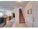 View of the staircase and an open floorplan with the kitchen and living room beyond at 12239 Fawn Brindle St, Riverview, FL 33578