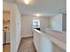 Bright hallway features neutral carpet, white walls, and leads to a laundry room with washer and dryer at 12239 Fawn Brindle St, Riverview, FL 33578