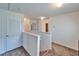 Second floor hallway with carpeted floor and white walls leading to several rooms at 12239 Fawn Brindle St, Riverview, FL 33578