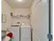 Bright laundry room with modern Samsung washer and dryer and wire shelving at 12239 Fawn Brindle St, Riverview, FL 33578