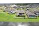 Aerial view of a spacious backyard with a white fence and a covered patio, perfect for outdoor entertaining at 12829 Tortoise Shell Pl, Riverview, FL 33579