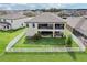 Aerial view of backyard with a large, fenced yard featuring covered patios, great for relaxing and entertaining guests at 12829 Tortoise Shell Pl, Riverview, FL 33579