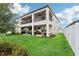 Expansive backyard featuring a covered patio with ceiling fans, outdoor seating, and a lush lawn at 12829 Tortoise Shell Pl, Riverview, FL 33579