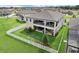 Aerial view of backyard with a large, fenced yard featuring covered patios, great for relaxing and entertaining guests at 12829 Tortoise Shell Pl, Riverview, FL 33579