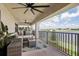 Charming balcony with comfortable seating, ceiling fans, and a scenic lake view at 12829 Tortoise Shell Pl, Riverview, FL 33579