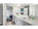 Bright bathroom with a double vanity, quartz countertops, and modern fixtures at 12829 Tortoise Shell Pl, Riverview, FL 33579