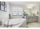 Bright bathroom featuring a tub, tile floor, and a double sink with white countertop at 12829 Tortoise Shell Pl, Riverview, FL 33579