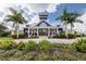 Community clubhouse boasting a stylish design and lush landscaping at 12829 Tortoise Shell Pl, Riverview, FL 33579