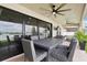 Outdoor dining area with a ceiling fan on a covered patio, perfect for entertaining guests at 12829 Tortoise Shell Pl, Riverview, FL 33579