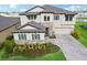 Beautiful two-story home featuring stone accents, blue shutters, and a well-manicured front yard with landscaping at 12829 Tortoise Shell Pl, Riverview, FL 33579